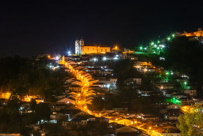 High angle view of illuminated buildings in city at night