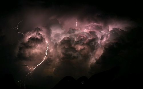 Low angle view of illuminated storm clouds