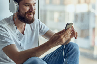 Midsection of man using mobile phone