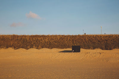 Scenic view of sandy beach against sky