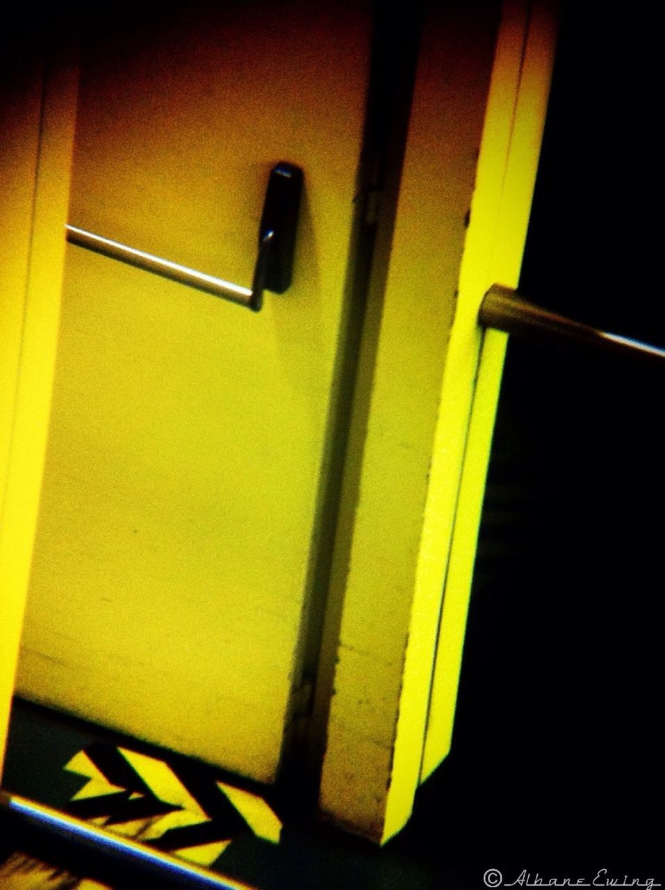 yellow, indoors, close-up, illuminated, high angle view, wall - building feature, no people, door, lighting equipment, communication, wall, technology, part of, auto post production filter, arrow symbol, orange color, metal, guidance, safety, connection