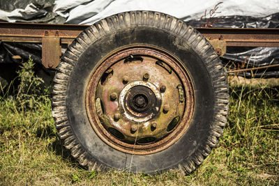 Close-up of abandoned tractor on field