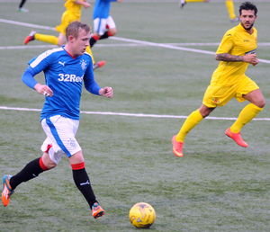 Full length of man running on soccer field