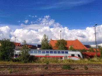 Railroad tracks against cloudy sky