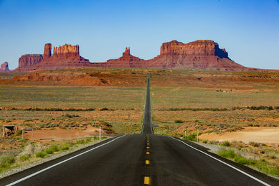 Road amidst rocks against clear sky