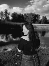 Woman looking away while standing on land