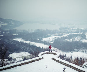 People skiing on snowcapped mountain against sky