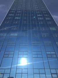 Low angle view of modern building against blue sky