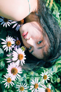 Close-up portrait of girl with pink flower