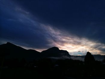 Scenic view of silhouette mountains against sky at sunset