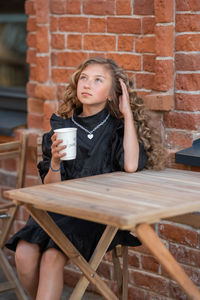 Portrait of beautiful young woman drinking water