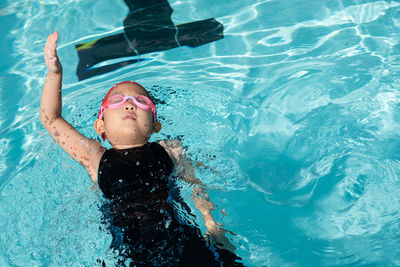 High angle view of boy swimming in pool