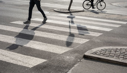 Low section of man riding bicycle on street