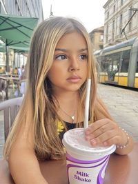 Portrait of young woman drinking glass