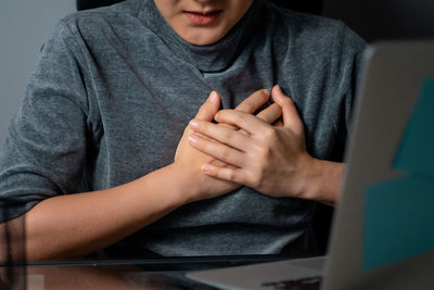 Midsection of man using mobile phone