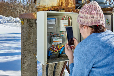 Rear view of woman using mobile phone