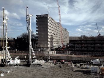 View of construction site against cloudy sky