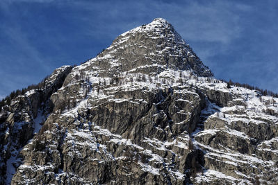 Low angle view of snowcapped mountain against sky