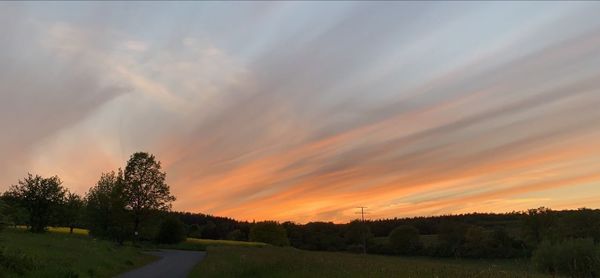 Scenic view of field against sky during sunset