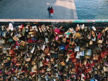 High angle view of padlocks on railing