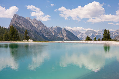 Scenic view of lake and mountains against sky