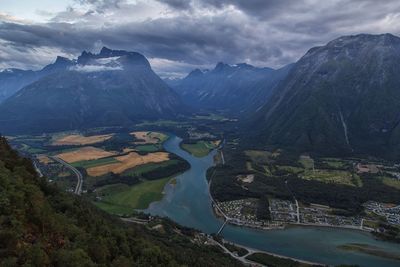 Scenic view of river amidst mountains against sky