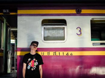 Portrait of man standing on train