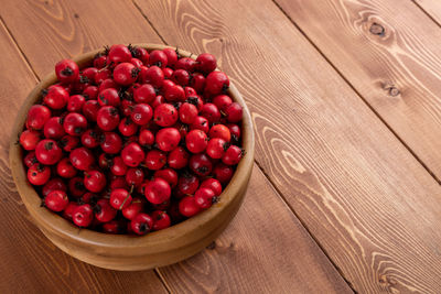 High angle view of berry fruits in bowl on table