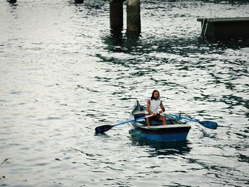 High angle view of man sitting in lake