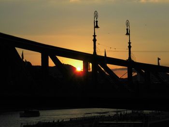 Silhouette bridge against sky during sunset