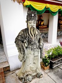 Statue of buddha against building