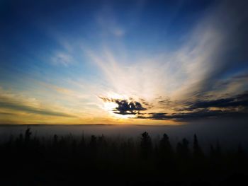 Scenic view of silhouette landscape against sky at sunset