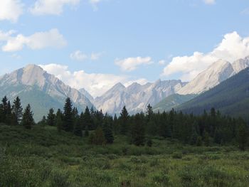 Scenic view of mountains against cloudy sky