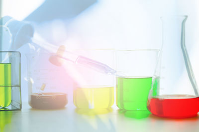 Close-up of colorful chemicals in laboratory glassware on table