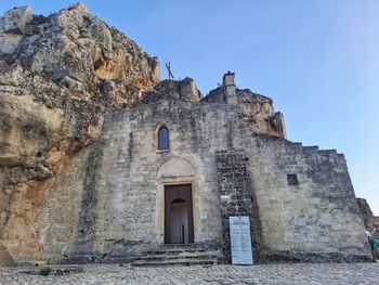 Low angle view of old ruins against clear sky