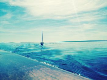 Sailboat in sea against sky