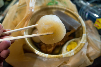 Close-up of hand holding bowl