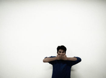 Portrait of young man against white background