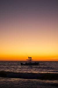 Scenic view of sea against clear sky during sunset