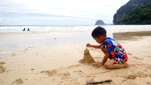 Boy making sandcastle at beach