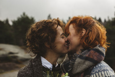 Lesbian couple kissing outdoors