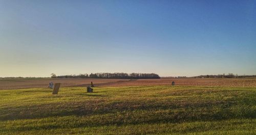 Scenic view of field against clear blue sky