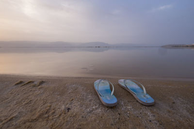 High angle view of shoes on beach against sky