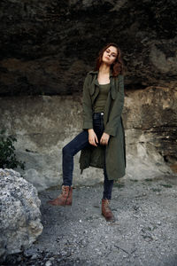 Young woman standing on rock