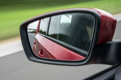 Reflection of car on side-view mirror