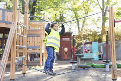 Boy balancing on rope at playground