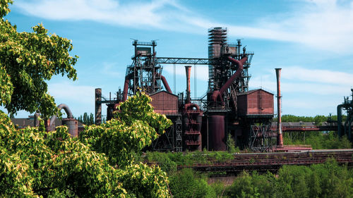 Abandoned factory against sky