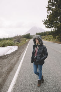 Full length of man standing on road against sky