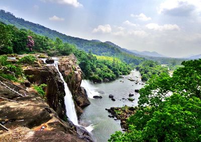 Scenic view of river amidst mountains against sky