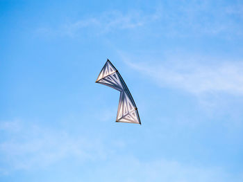 Low angle view of flag against blue sky